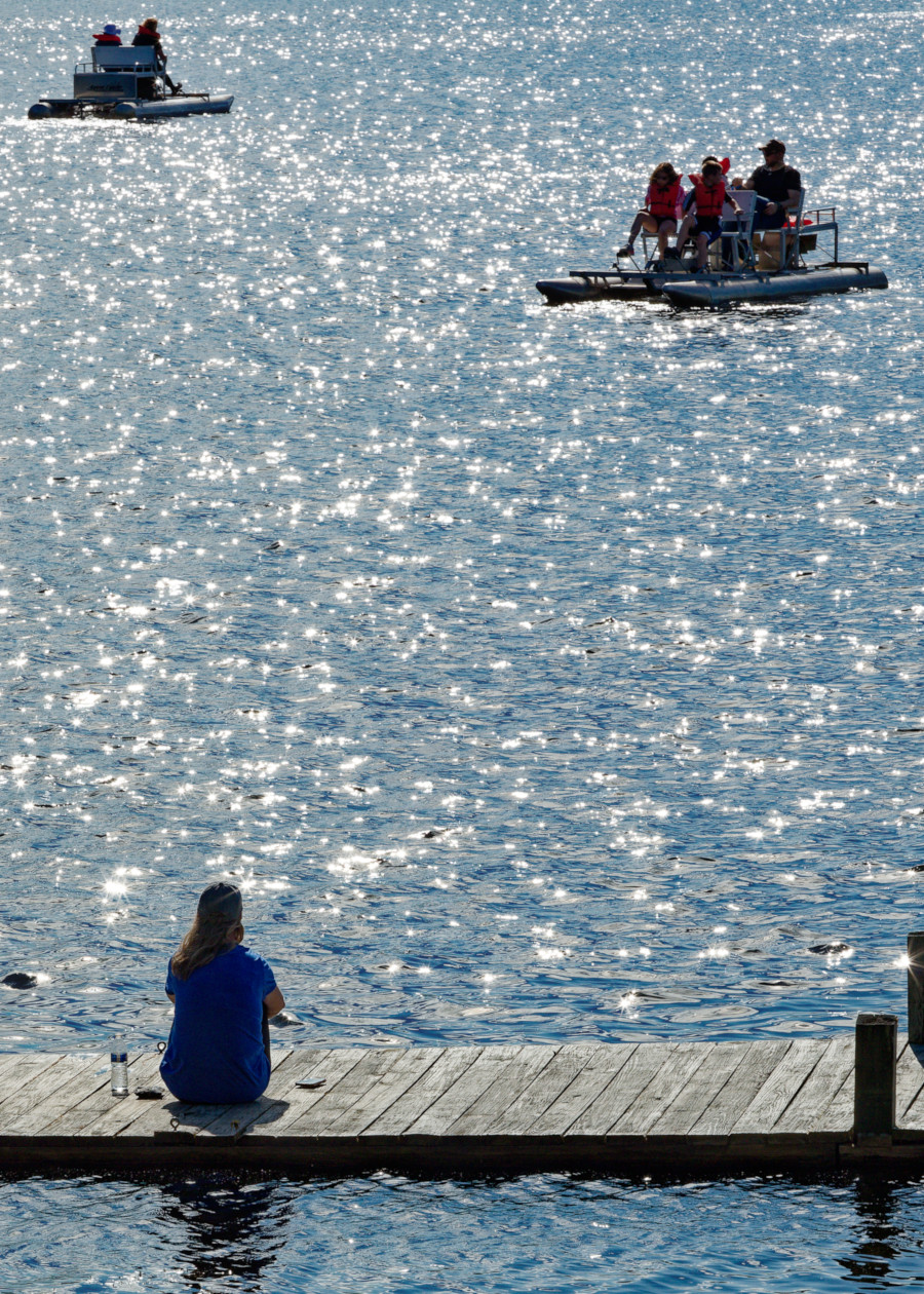 Pontoon boats over sparkling waters